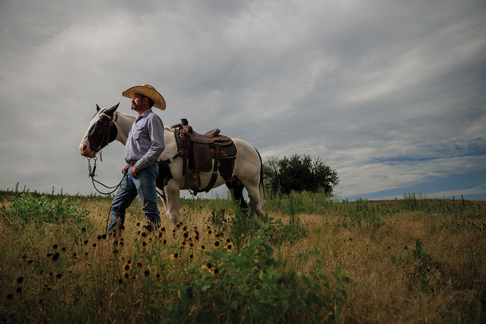 Chance Tynes in field with horse