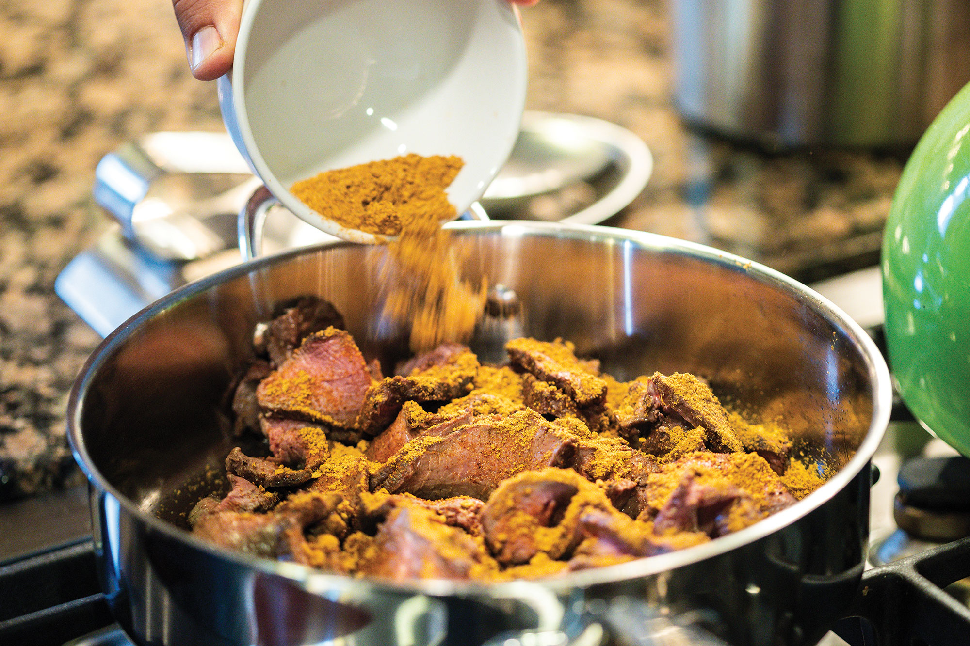 Adding taco seasoning to meat