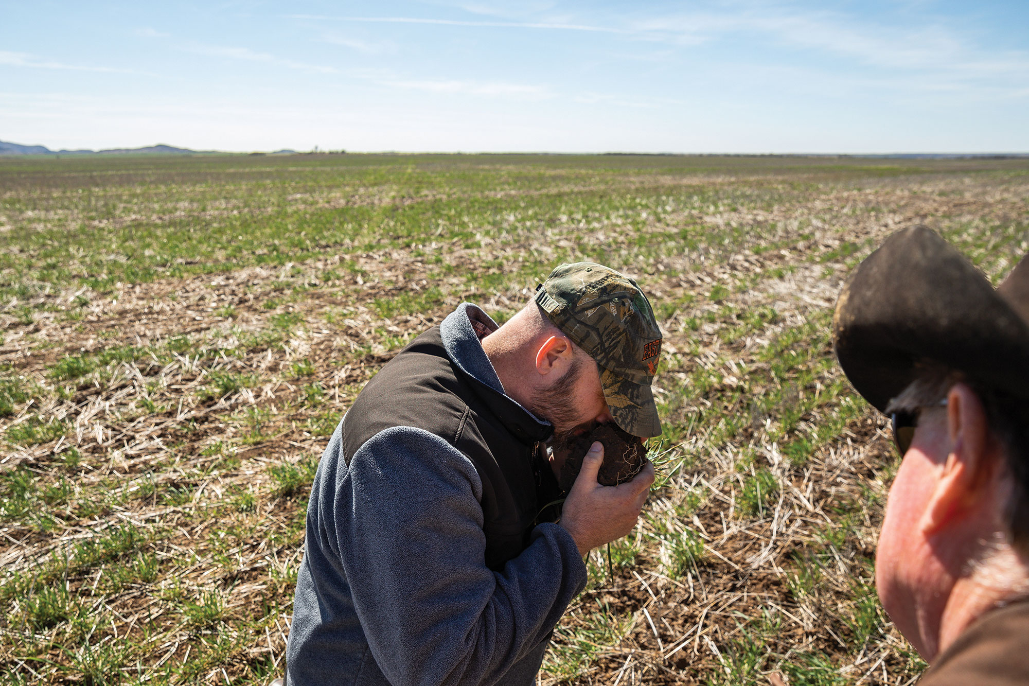 Jim Johnson demonstrates the smell that healthy soil should have.