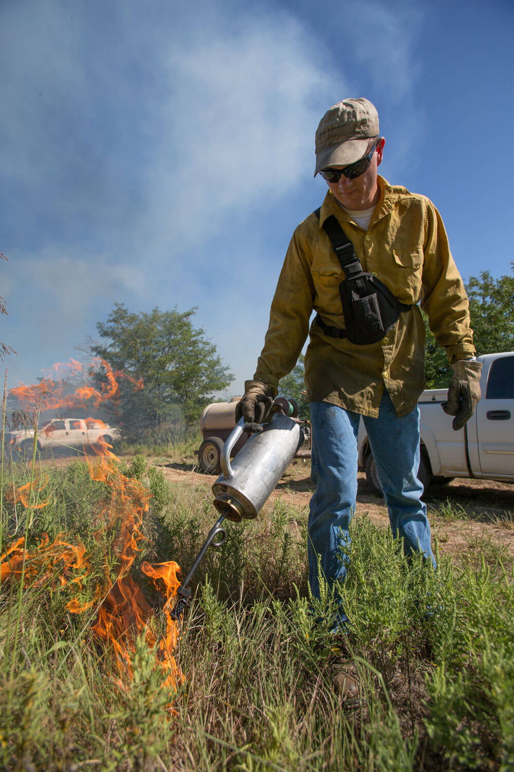 Steven Smith starts prescribed burn with drip torch.