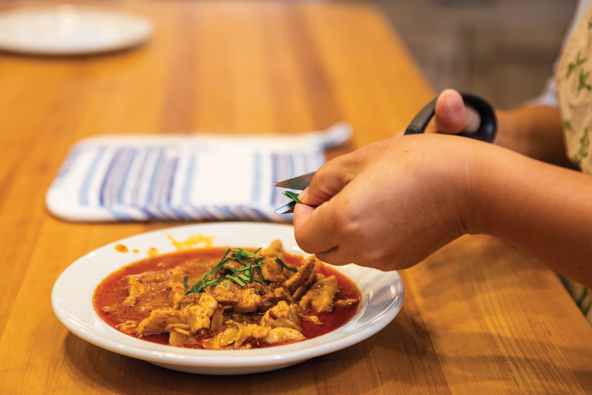 Garnishing the Thai Chicken Curry with Citrus Leaves