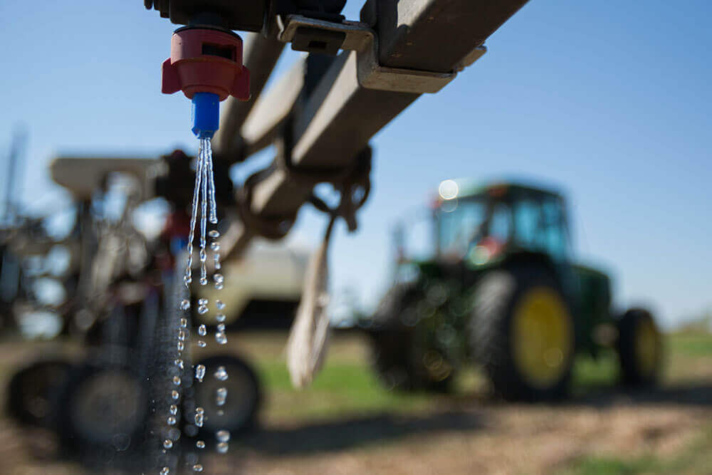 Tractor spraying nitrogen fertilizer